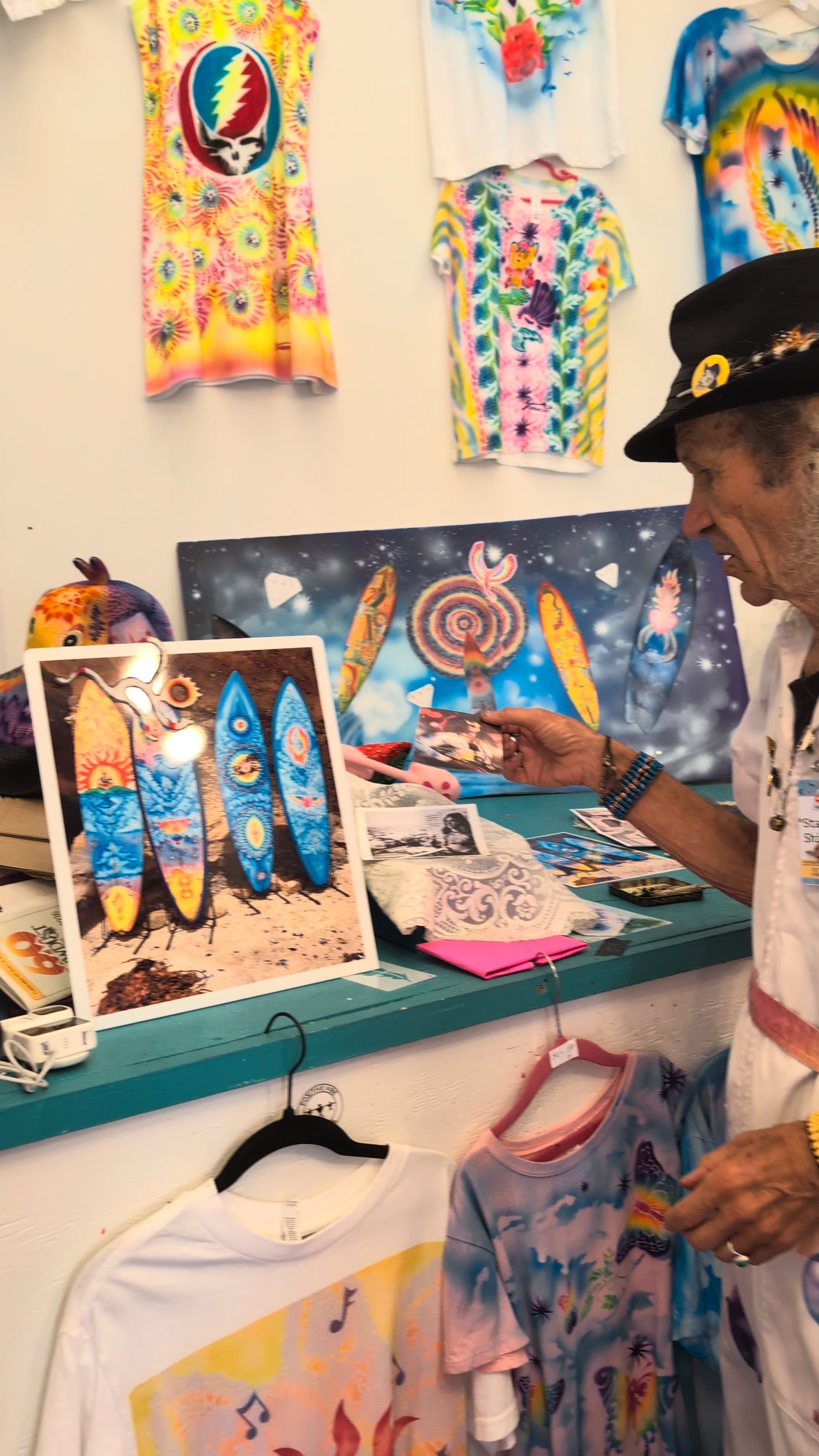 Star Shields sorting through original artwork at his booth